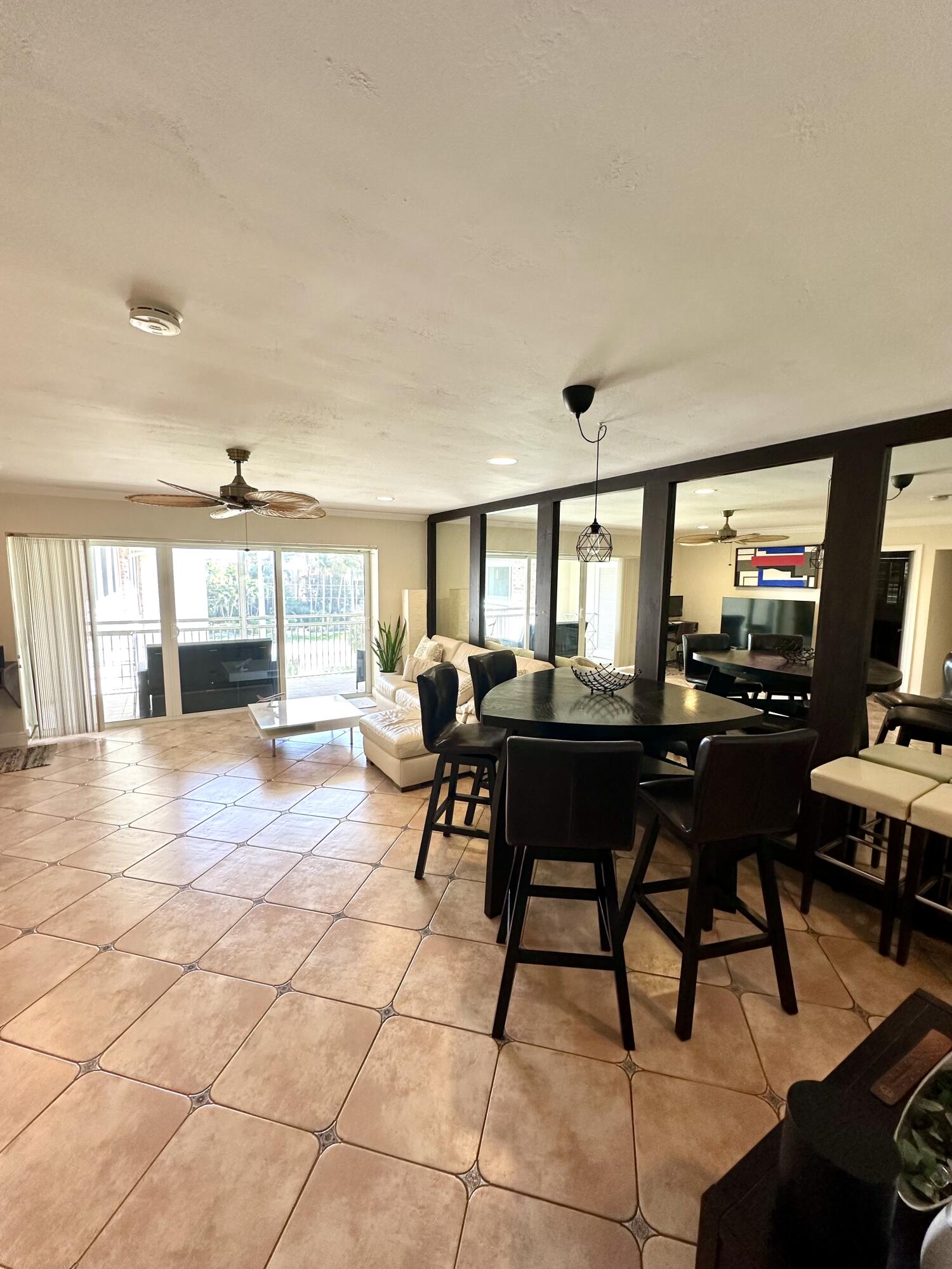 2501 South Ocean Boulevard, Unit 3040 Boca Raton, FL 33432 - Photo 5 of 22 a living room with furniture a window and a flat screen tv