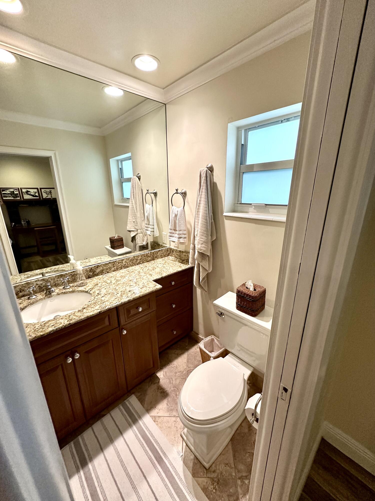 2501 South Ocean Boulevard, Unit 3040 Boca Raton, FL 33432 - Photo 10 of 22 a bathroom with a granite countertop toilet sink and mirror