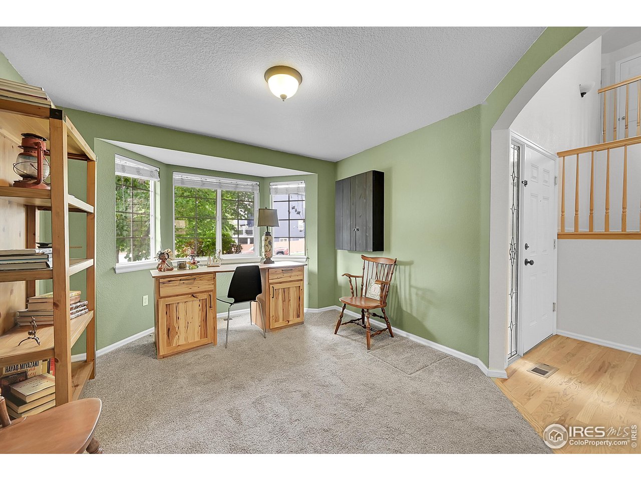 514 Peyton Drive Fort Collins, CO 80525 - Photo 16 of 40 a living room with furniture a large window and a flat screen tv