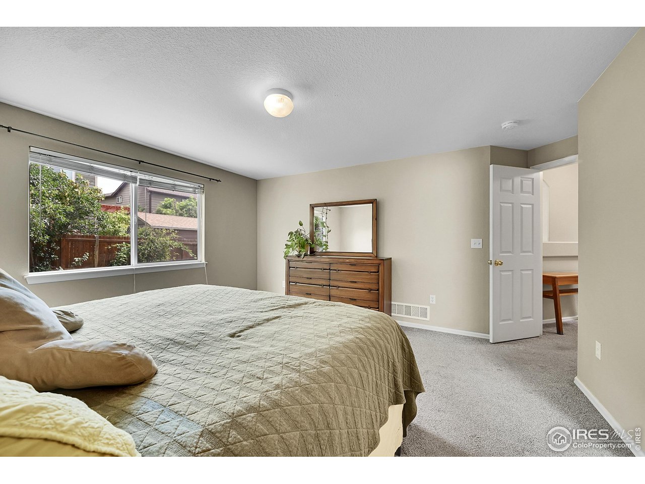 514 Peyton Drive Fort Collins, CO 80525 - Photo 20 of 40 a bedroom with a bed and a large window