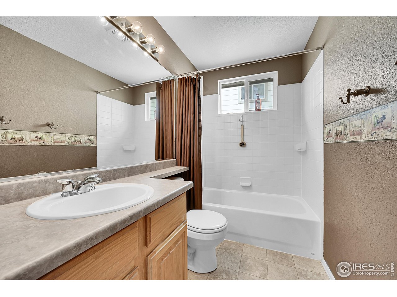 514 Peyton Drive Fort Collins, CO 80525 - Photo 25 of 40 a bathroom with a sink toilet a mirror and shower