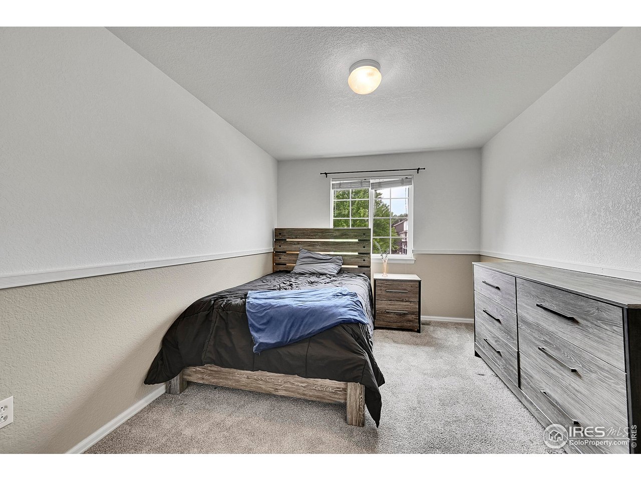 514 Peyton Drive Fort Collins, CO 80525 - Photo 27 of 40 a bedroom with a bed and a window