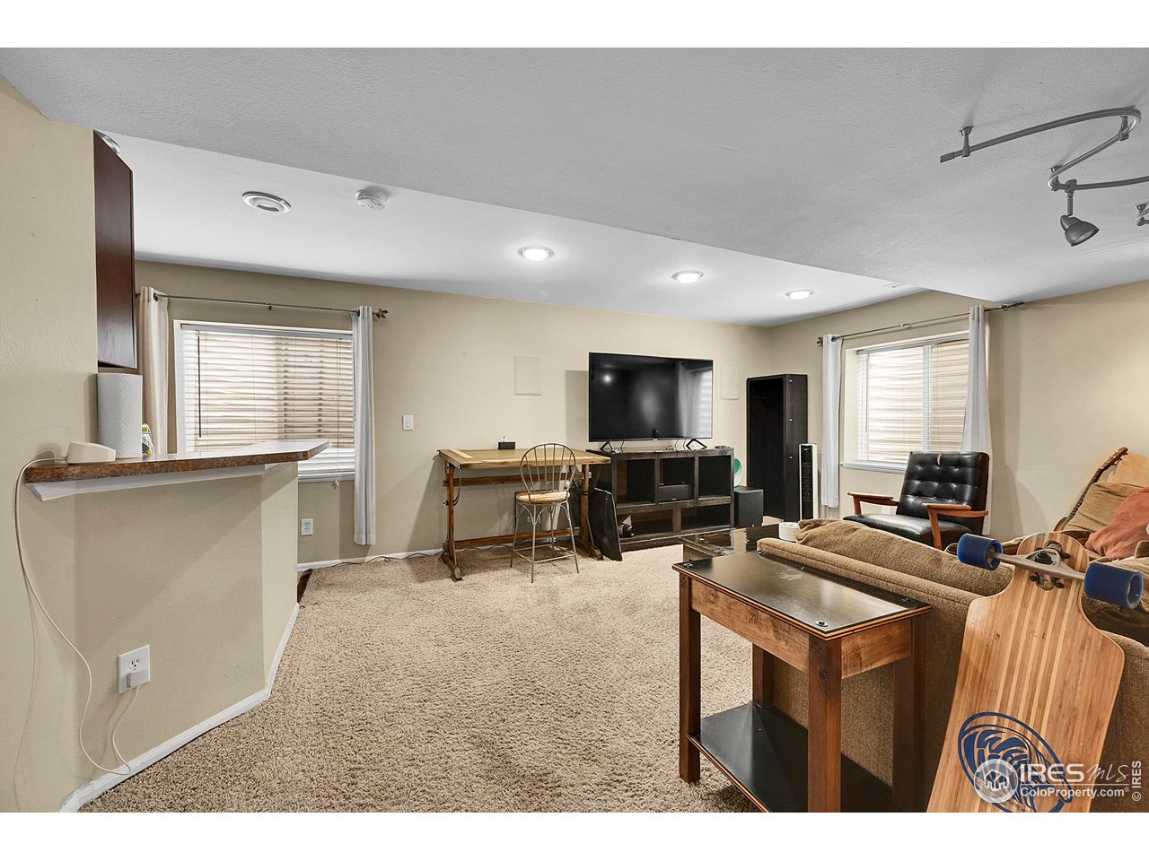 514 Peyton Drive Fort Collins, CO 80525 - Photo 28 of 40 a living room with furniture a flat screen tv and large window