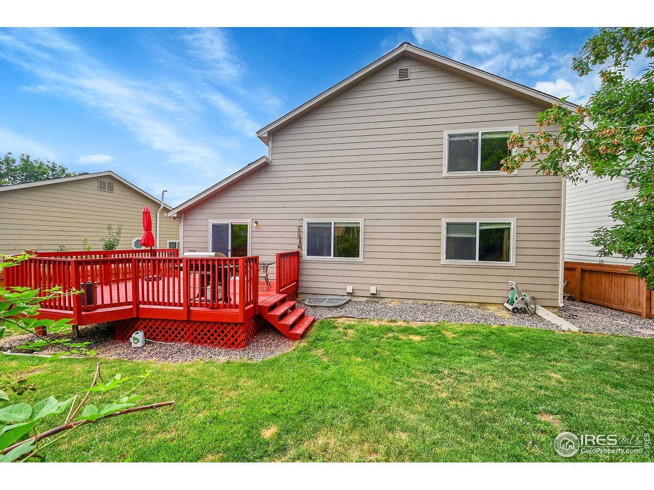 514 Peyton Drive Fort Collins, CO 80525 - Photo 34 of 40 a view of a house with a yard and deck