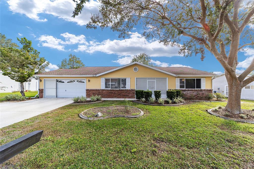 11431 Southwest 84th Court Road Ocala, FL 34481 - Photo 1 of 1 a front view of a house with garden