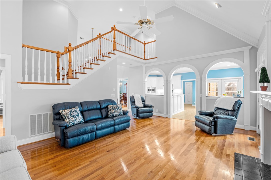 100 Farm Terrace Court Easley, SC 29642 - Photo 15 of 47 An inviting interior space features an open concept with vaulted ceilings and gleaming hardwood floors.