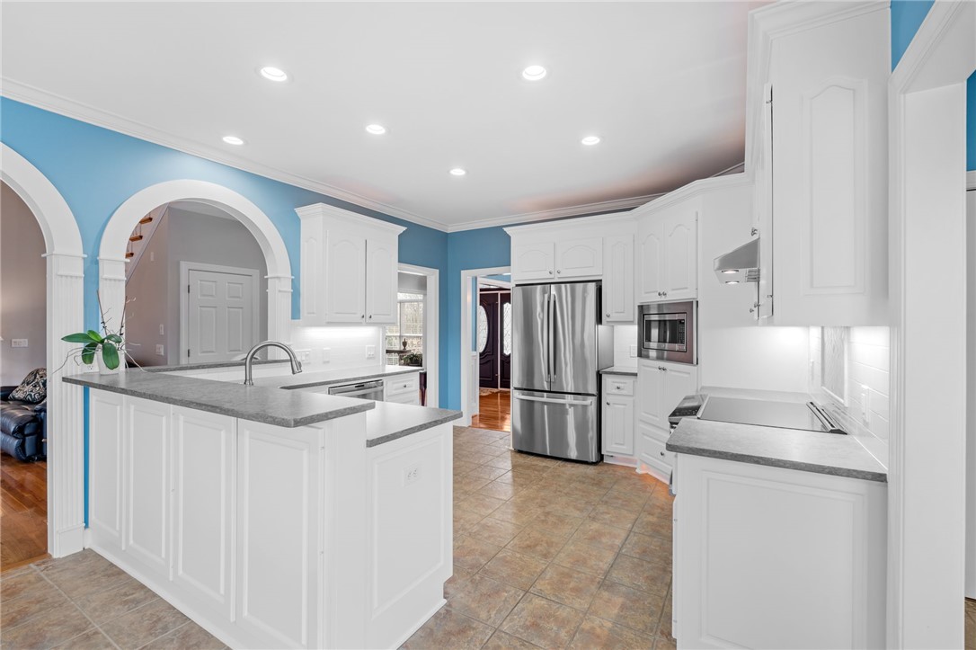 100 Farm Terrace Court Easley, SC 29642 - Photo 18 of 47 This kitchen features a practical layout with stainless steel appliances and abundant white cabinetry.