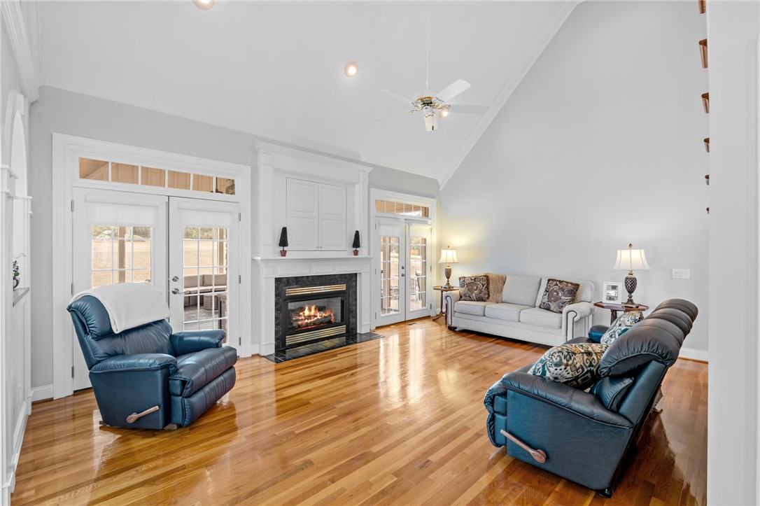 100 Farm Terrace Court Easley, SC 29642 - Photo 2 of 47 This bright living space features gleaming hardwood floors and a cozy fireplace, perfect for gatherings.