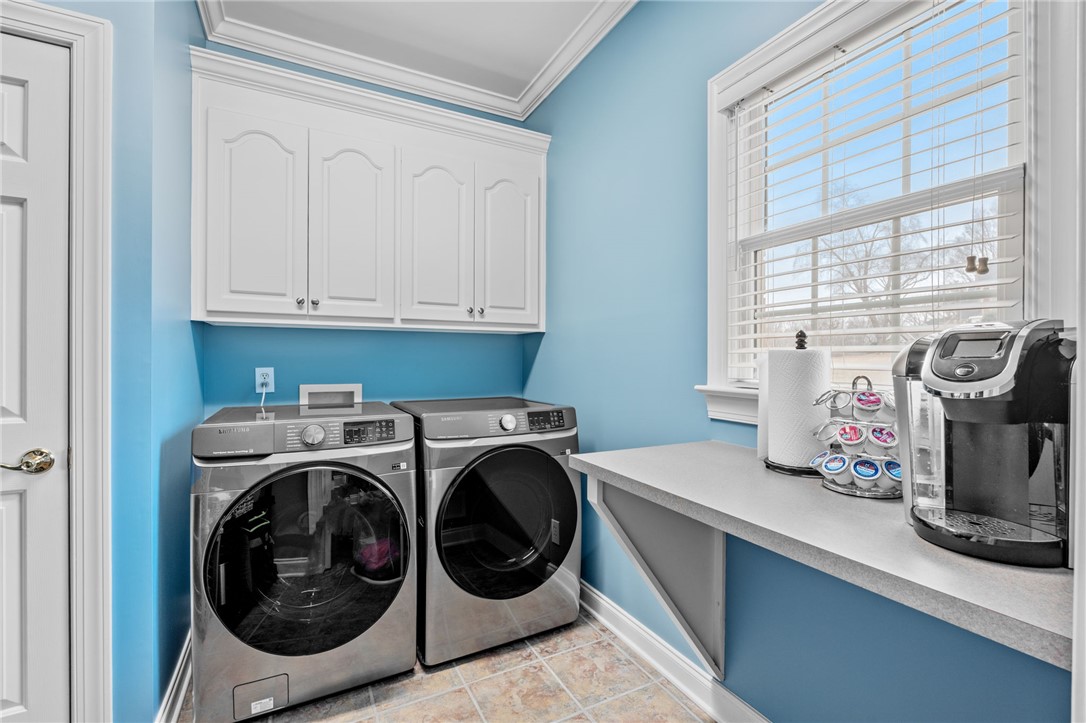 100 Farm Terrace Court Easley, SC 29642 - Photo 24 of 47 This bright utility room features practical overhead cabinets and convenient laundry appliances.