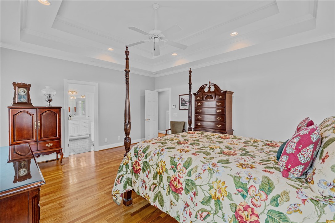 100 Farm Terrace Court Easley, SC 29642 - Photo 26 of 47 This tranquil bedroom features warm wood floors and an adjacent bathroom, creating a private retreat.