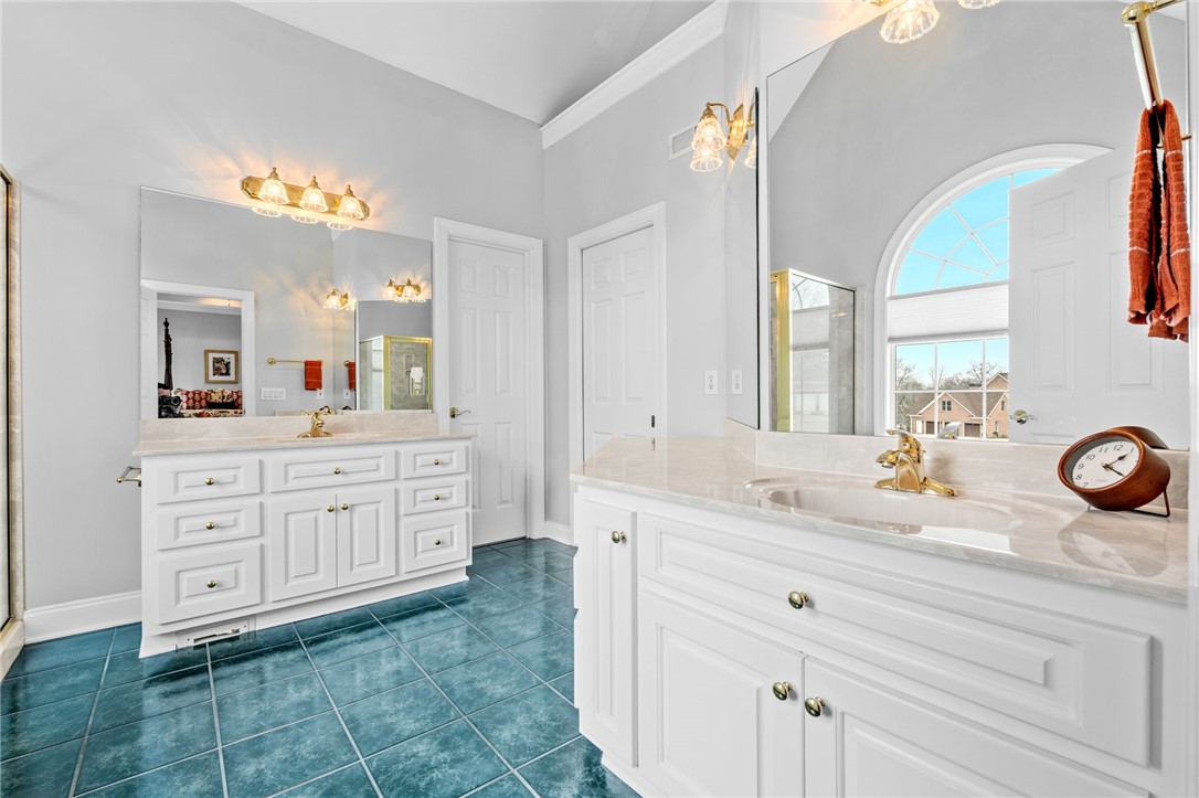 100 Farm Terrace Court Easley, SC 29642 - Photo 27 of 47 This spacious bathroom offers dual vanities and an arched window, creating a bright and airy atmosphere.