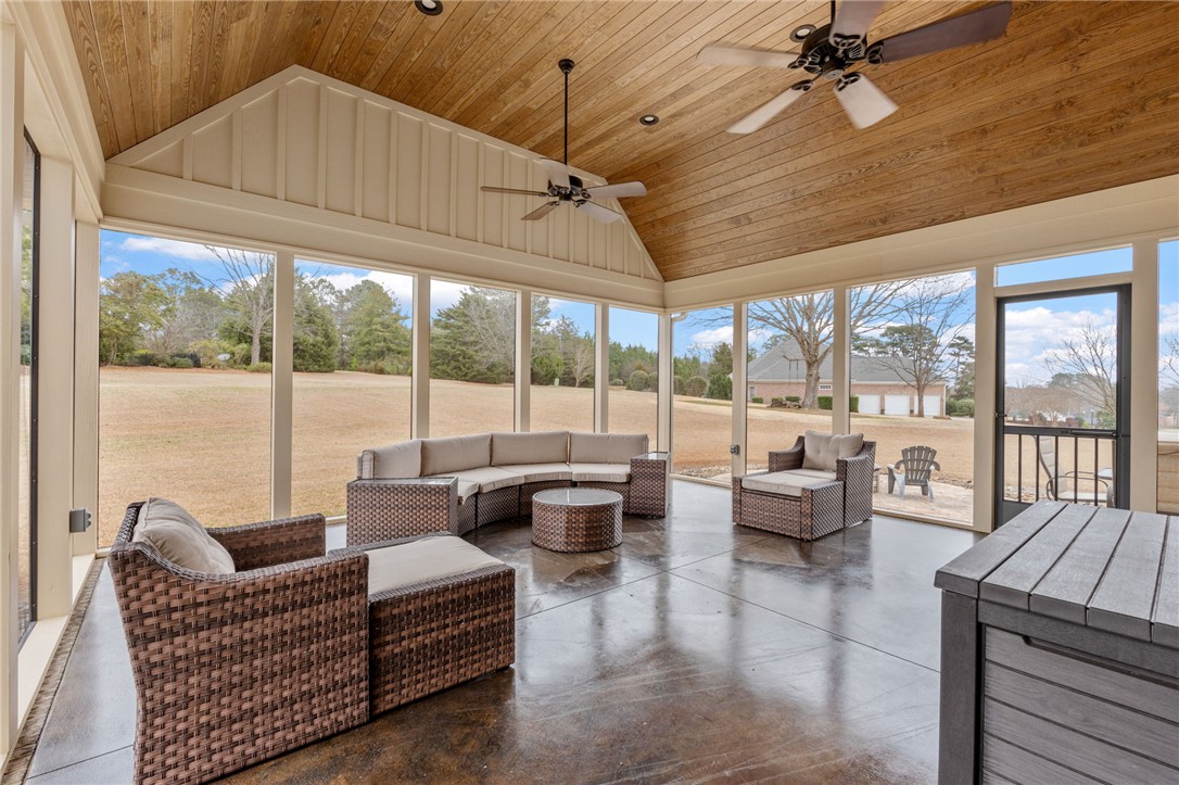 100 Farm Terrace Court Easley, SC 29642 - Photo 39 of 47 This airy sunroom features ample space, a vaulted wood ceiling, and expansive views.