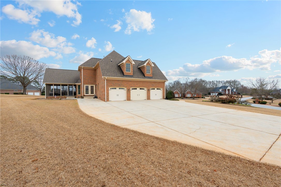 100 Farm Terrace Court Easley, SC 29642 - Photo 45 of 47 Brick residence features a three-car garage and a spacious concrete driveway.