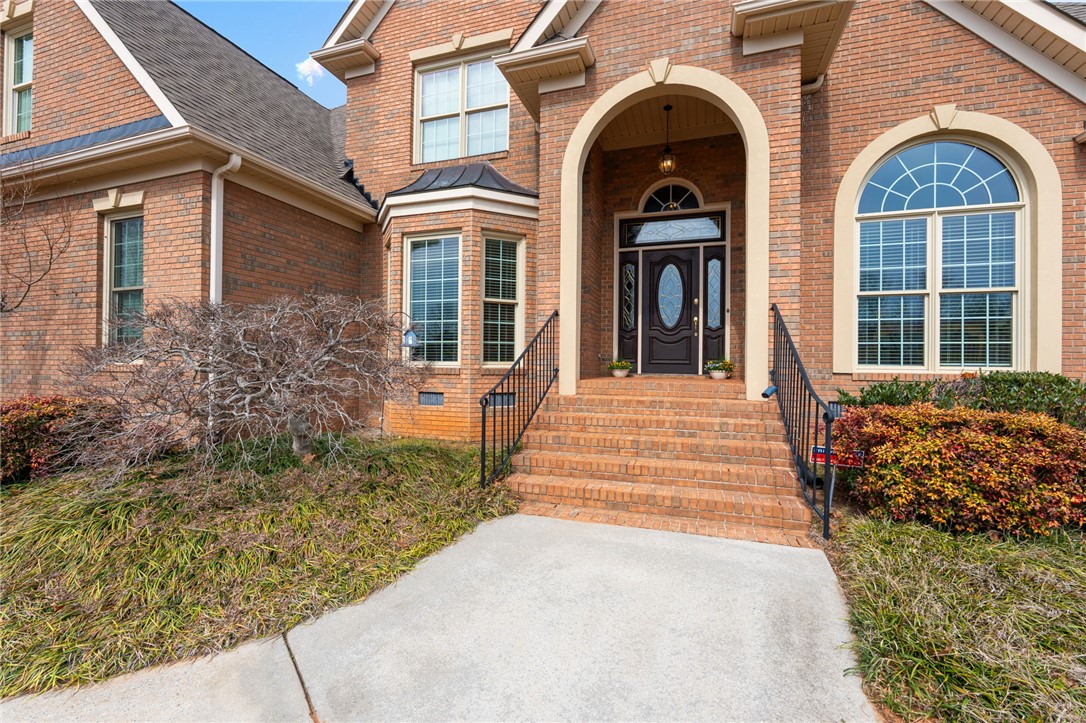 100 Farm Terrace Court Easley, SC 29642 - Photo 6 of 47 Brick facade with arched entryways and a classic dark wood front door welcomes you home.