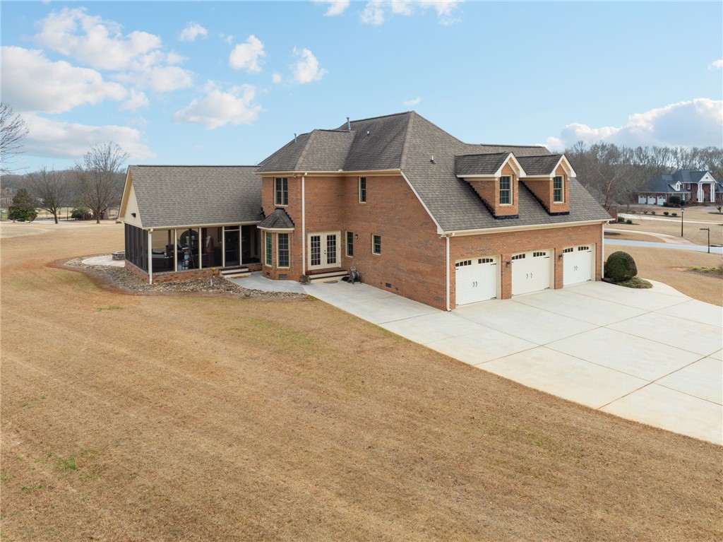 100 Farm Terrace Court Easley, SC 29642 - Photo 9 of 47 This spacious property features a classic brick exterior and an expansive lawn, ideal for outdoor living.