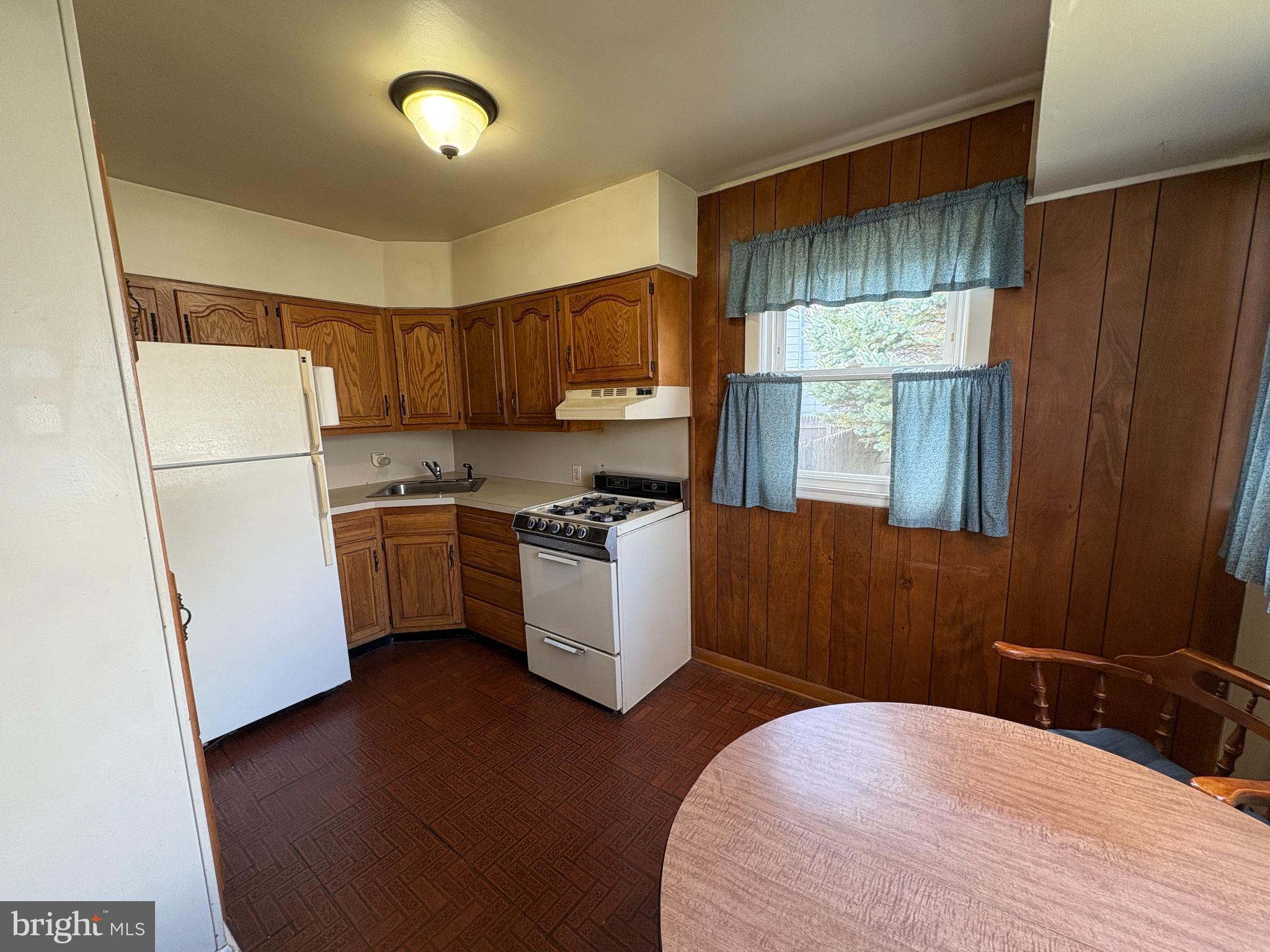 63 Gerard Road Hamilton, NJ 08620 - Photo 4 of 19 a kitchen with a refrigerator a stove a sink dishwasher and wooden cabinets