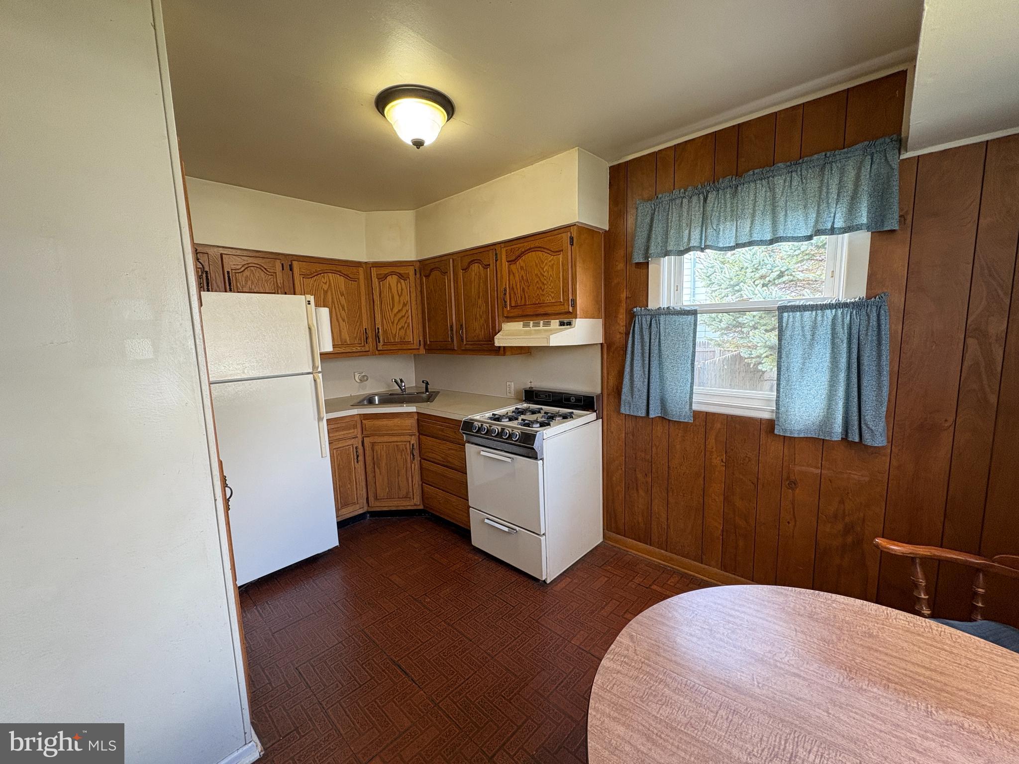 63 Gerard Road Hamilton, NJ 08620 - Photo 5 of 19 a kitchen with a refrigerator a stove a sink dishwasher and a refrigerator with wooden floor