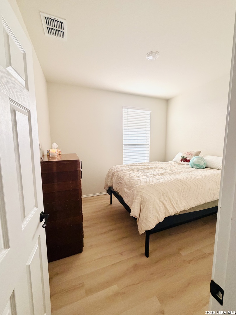 10255 Crossbuck Converse, TX 78109 - Photo 11 of 19 a bedroom with a bed and a dresser