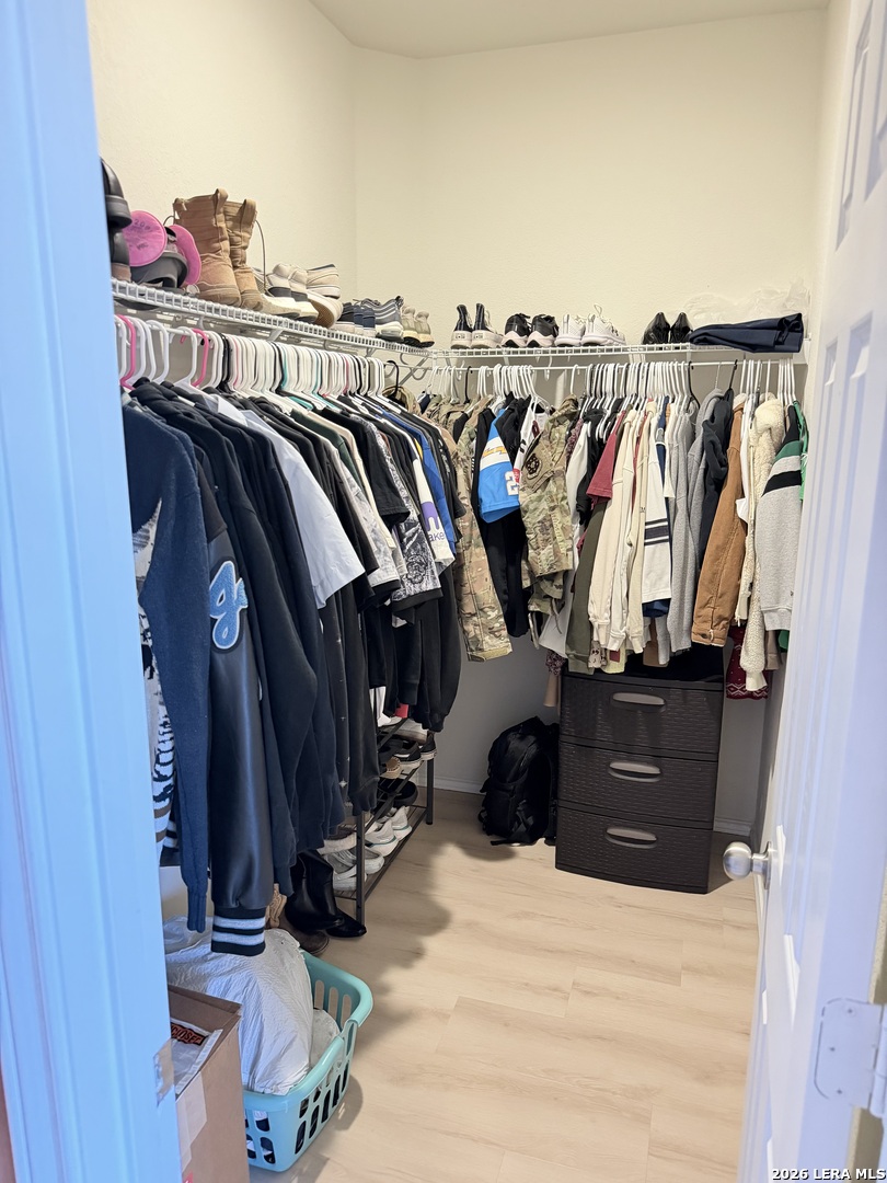 10255 Crossbuck Converse, TX 78109 - Photo 14 of 19 a view of walk in closet with clothes and shoes