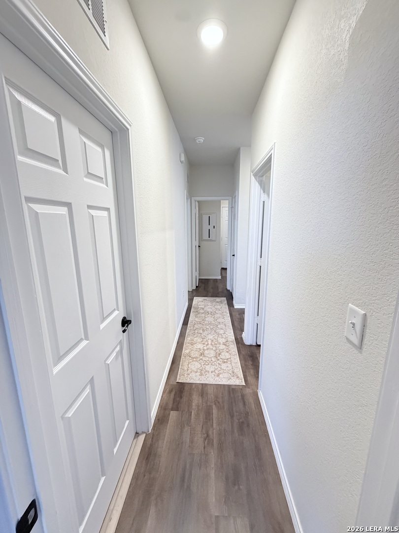 10255 Crossbuck Converse, TX 78109 - Photo 15 of 19 a view of a hallway with wooden floor and staircase