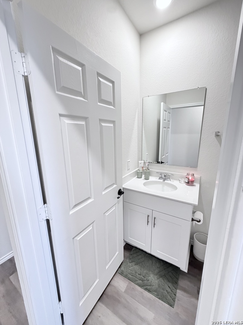 10255 Crossbuck Converse, TX 78109 - Photo 16 of 19 a bathroom with a sink a mirror and a vanity