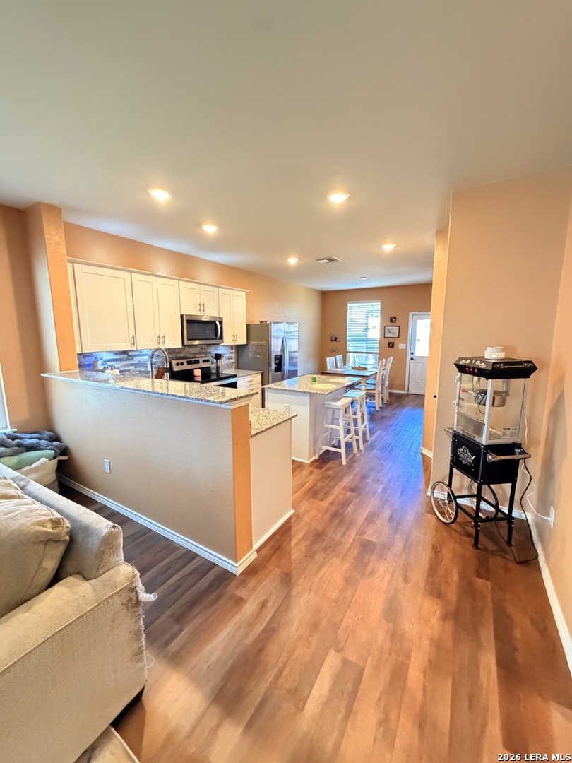 10255 Crossbuck Converse, TX 78109 - Photo 3 of 19 a kitchen with a table chairs refrigerator and microwave