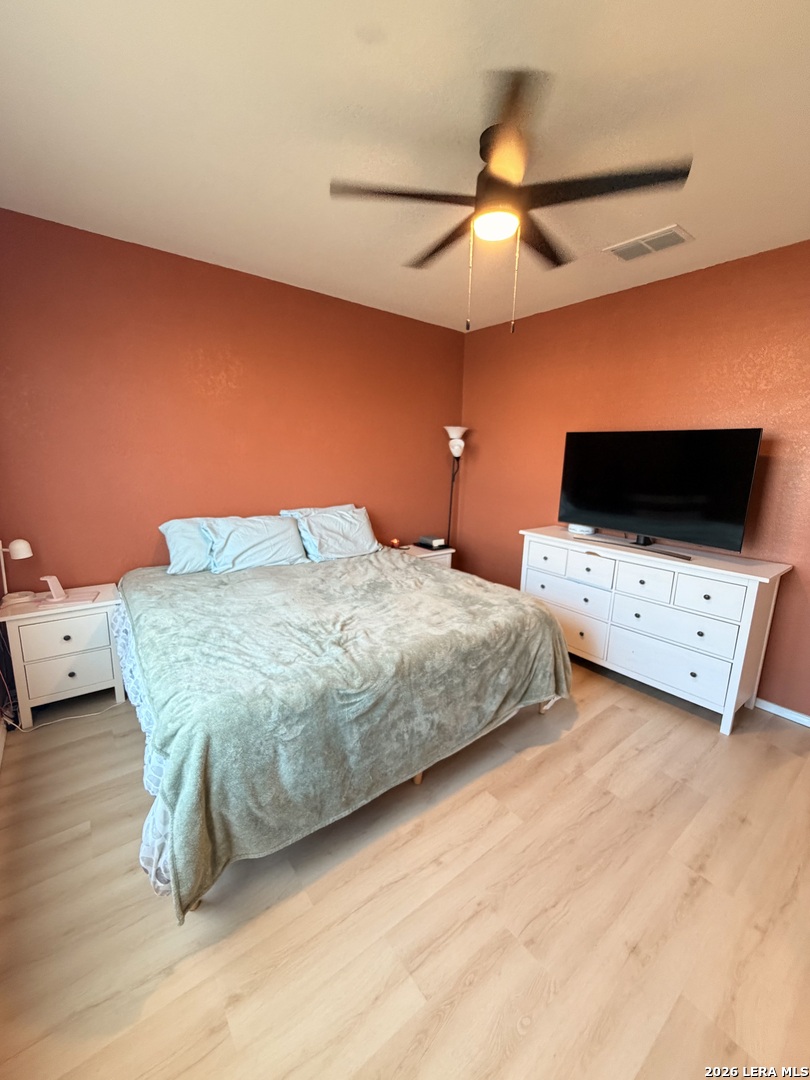 10255 Crossbuck Converse, TX 78109 - Photo 9 of 19 a bedroom with a bed and a chandelier