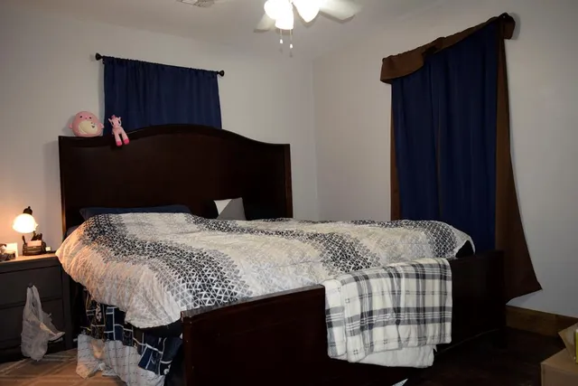 a bedroom that has a bed and a chair in it