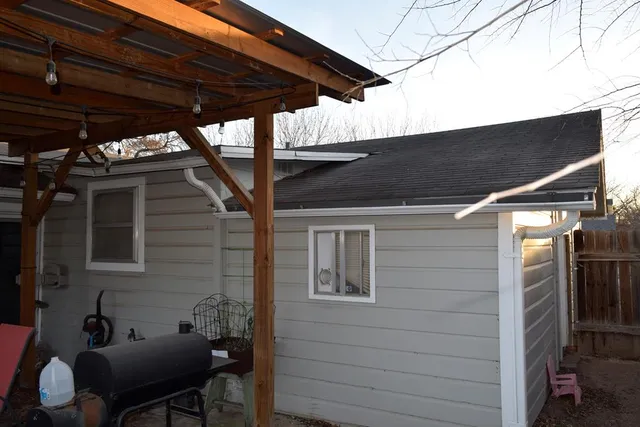 a backyard of a house with table and chairs