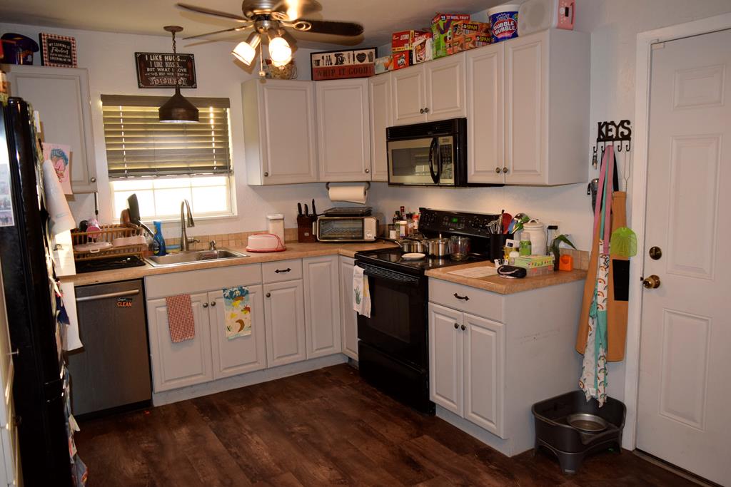 420 Bluebonnet Drive Kerrville, TX 78028 - Photo 9 of 22 a kitchen with a sink stove and microwave