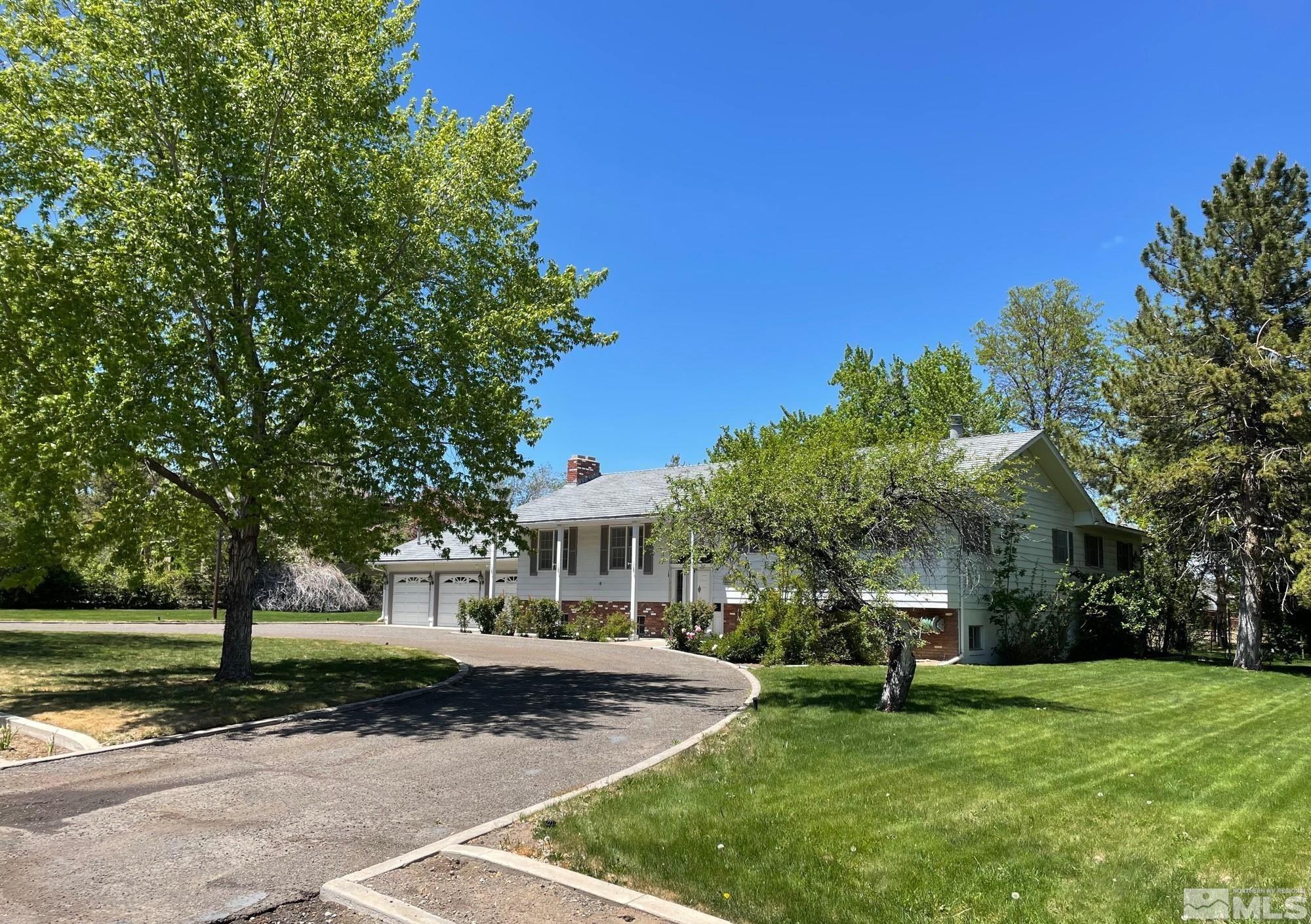 1545 Meadowview Lane Reno, NV 89509 - Photo 1 of 36 a front view of a house with a yard