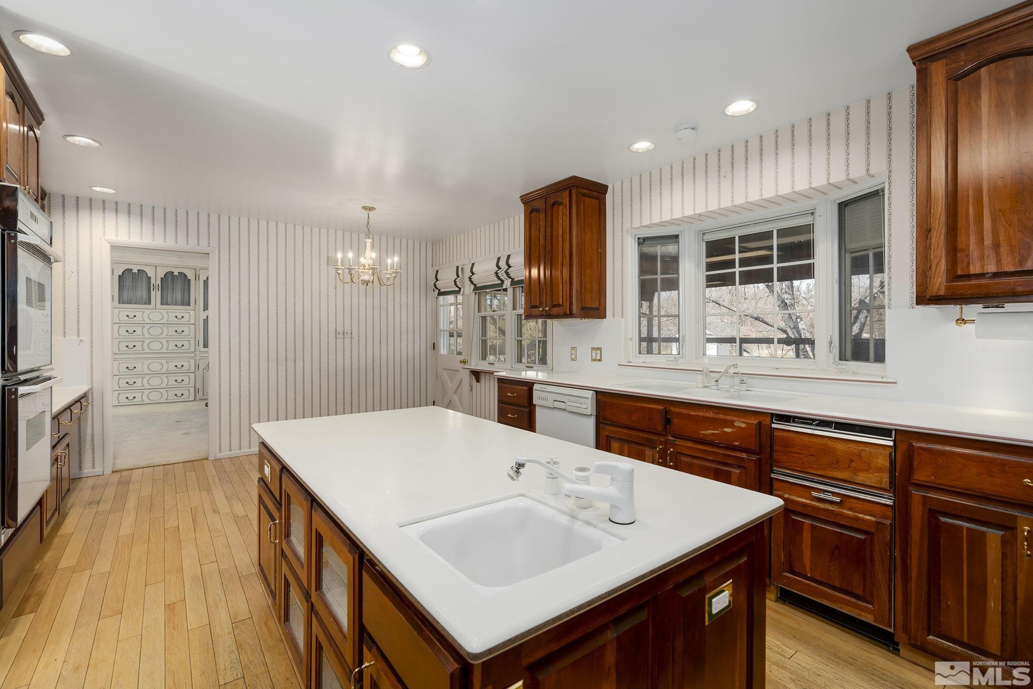 1545 Meadowview Lane Reno, NV 89509 - Photo 11 of 36 a large kitchen with kitchen island a sink appliances and a counter space