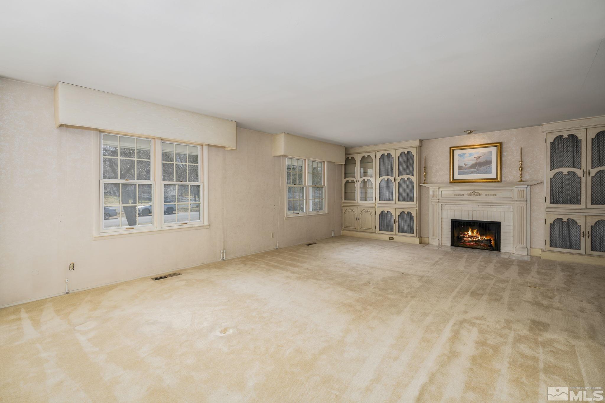 1545 Meadowview Lane Reno, NV 89509 - Photo 5 of 36 a view of a livingroom with an empty space and a fireplace