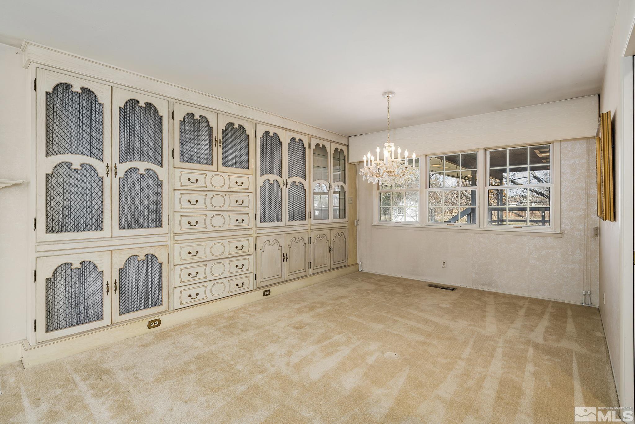 1545 Meadowview Lane Reno, NV 89509 - Photo 8 of 36 a view of an empty room with window and chandelier