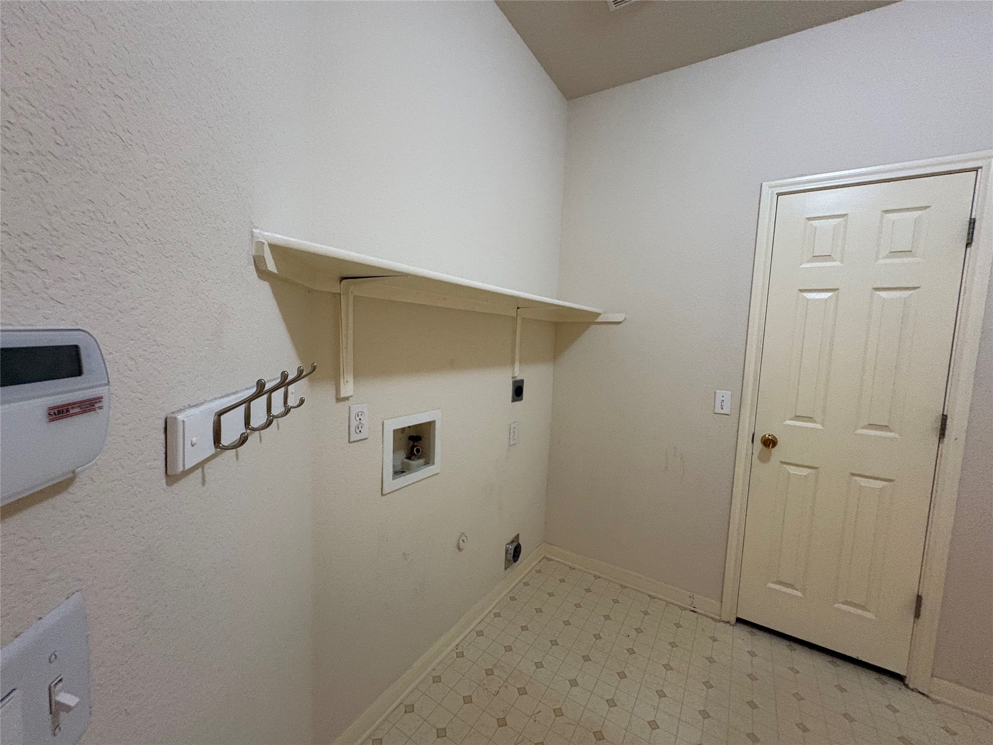 7006 Rambollet Terrace Round Rock, TX 78681 - Photo 22 of 38 A well-appointed laundry area offers convenient hookups and practical shelving for storage.