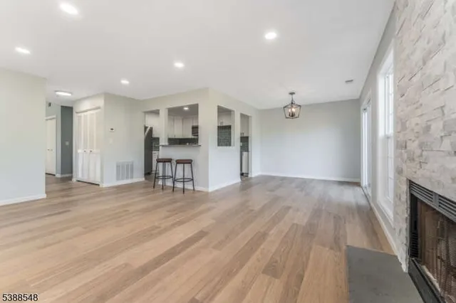 a view of a room with wooden floor and windows
