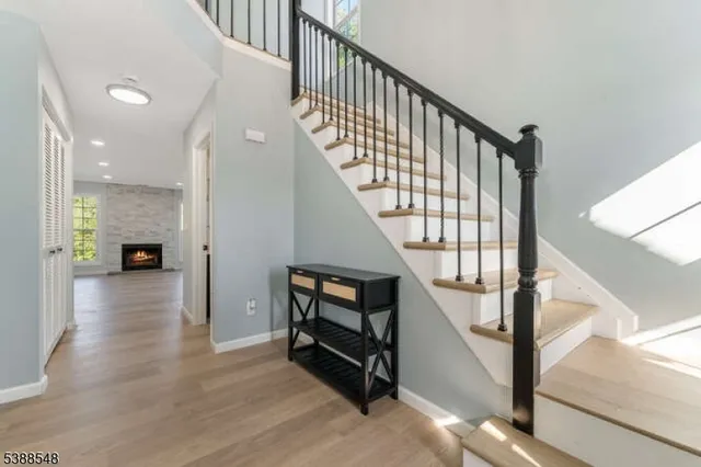 a view of entryway and hall with wooden floor