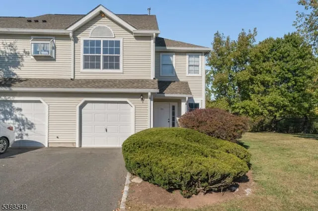 a view of a house with a garage and balcony