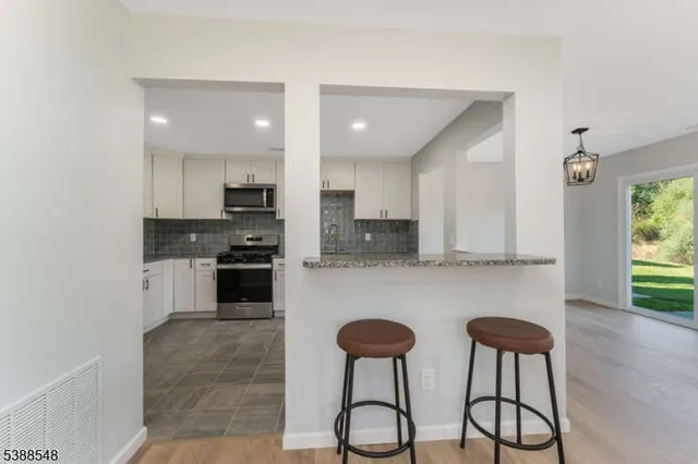 a view of entryway with wooden floor and stairs