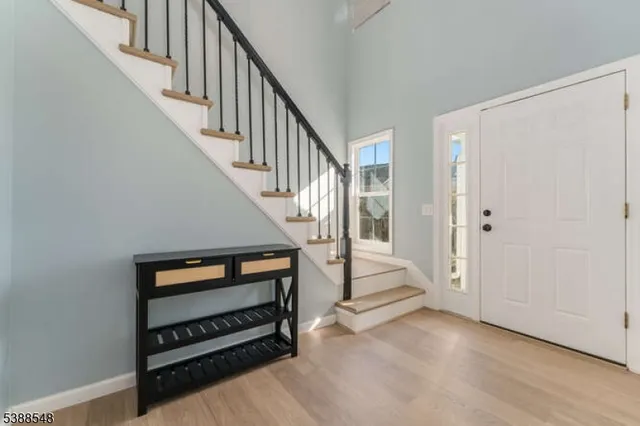 a view of an entryway with wooden floor and stairs