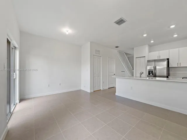 a view of kitchen with stainless steel appliances refrigerator oven