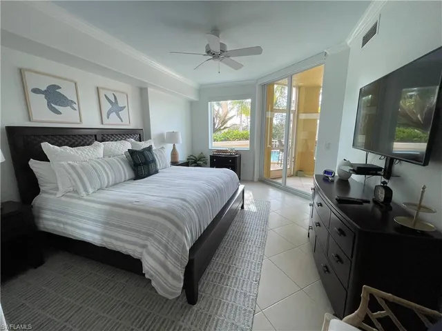 a spacious bedroom with a large bed and a flat tv screen on dresser