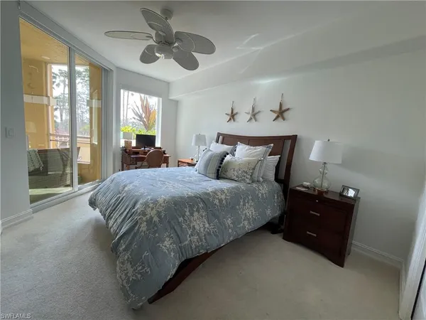 a spacious bedroom with a bed and a chandelier