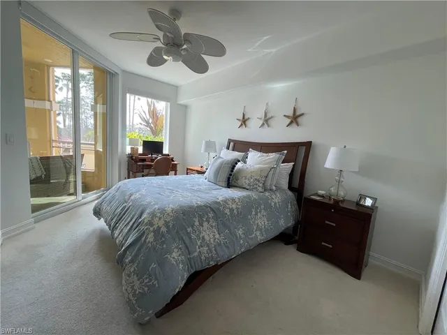 a spacious bedroom with a bed and a chandelier