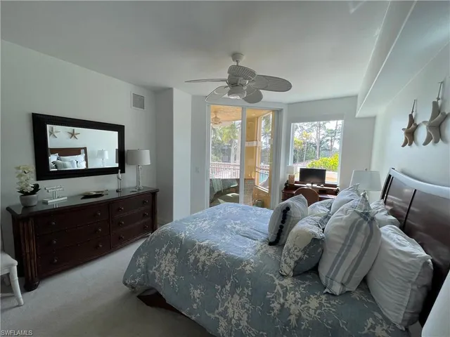 a bedroom with a bed and a flat tv screen on dresser