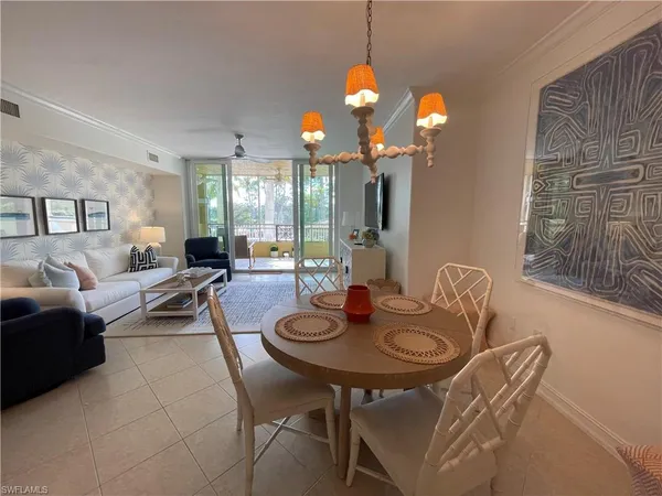 a view of a dining room with furniture and chandelier