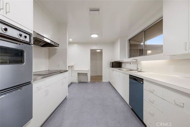 a bedroom with a bed and a white cabinet