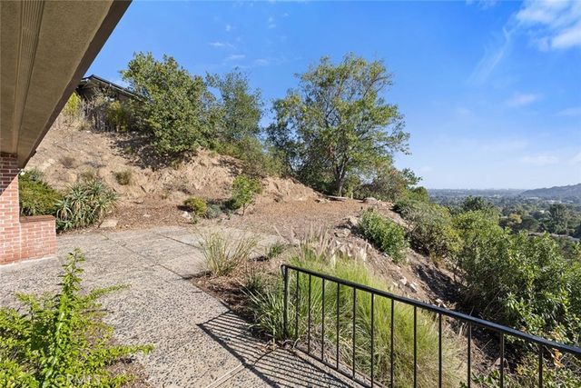 an aerial view of a residential apartment building with plants and large trees