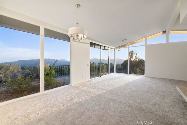 a view of a big room with windows