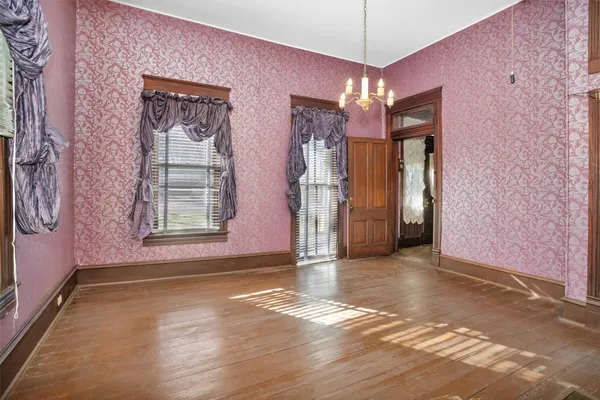 a view of a room with wooden floor and door